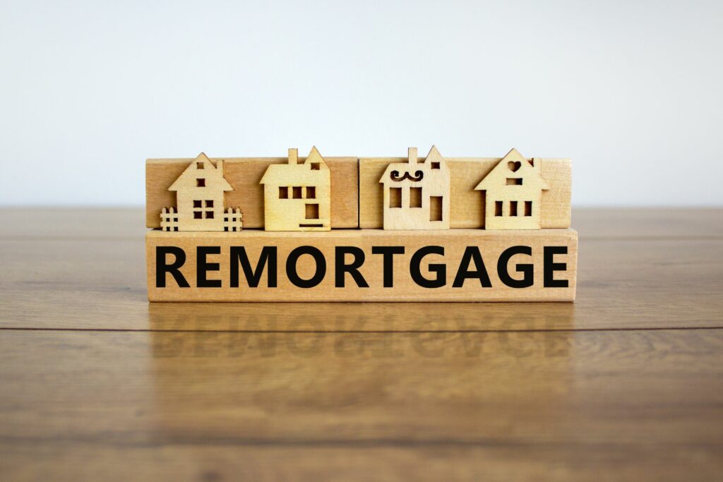 a wooden sign with the words remortgage and four model homes